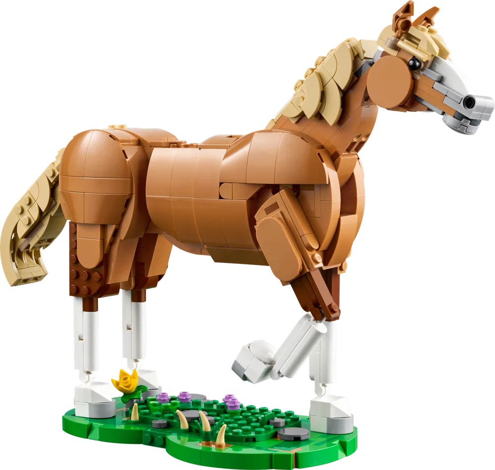 A LEGO-built brown horse model stands dynamically on a green base adorned with small flowers, its front leg lifted.