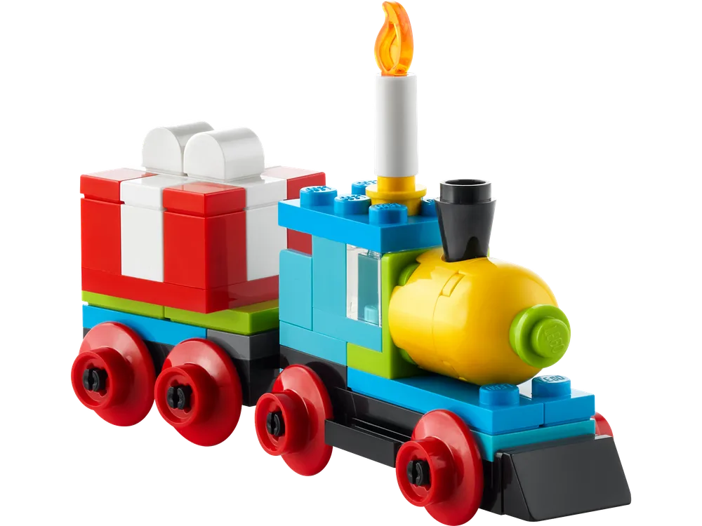 A vibrant LEGO Duplo train, featuring a blue engine with a yellow front, a tall white candle with an orange flame, and a red and white gift car, all on red wheels.