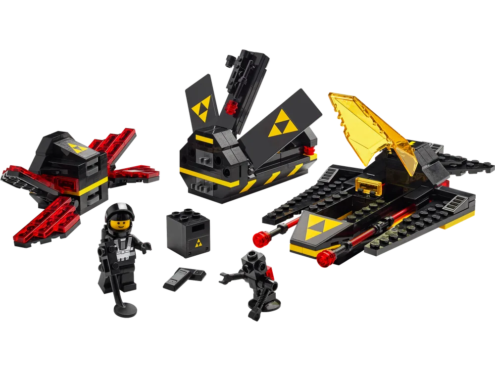 A dismantled LEGO Blacktron Cruiser set shows its modular components, including a red-winged drone, a black cargo pod, and the main spacecraft with a yellow canopy. Two Blacktron minifigures stand nearby, a classic astronaut and a smaller robot.