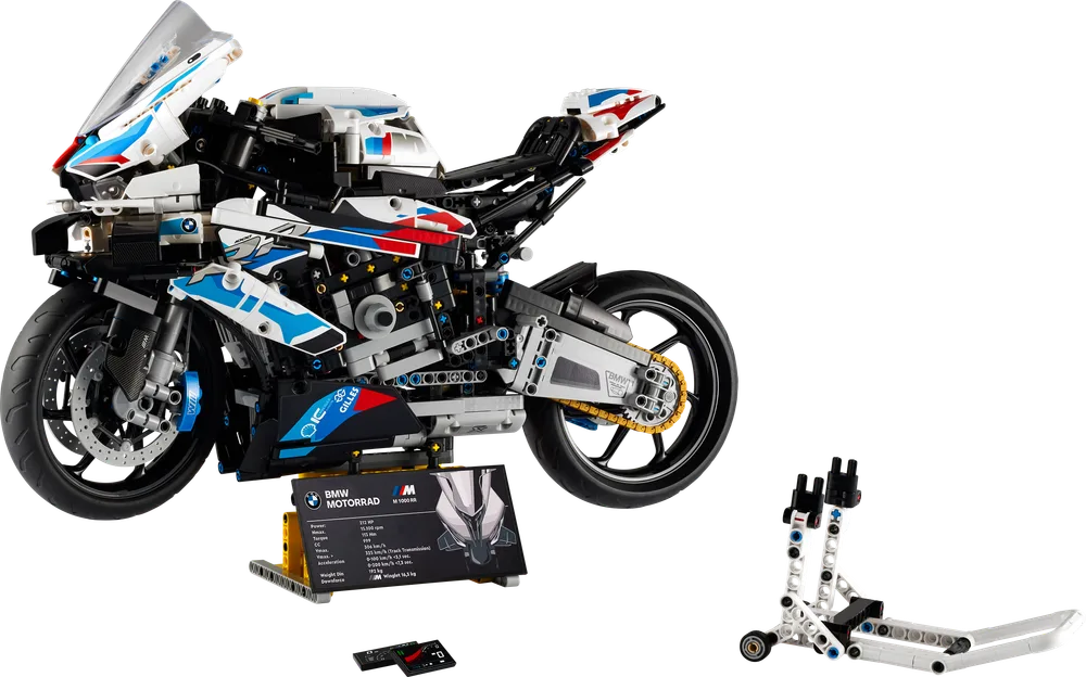 The LEGO Technic BMW M 1000 RR motorcycle model is displayed with its display stand and information plate, showcasing its intricate details and a separate bike stand.