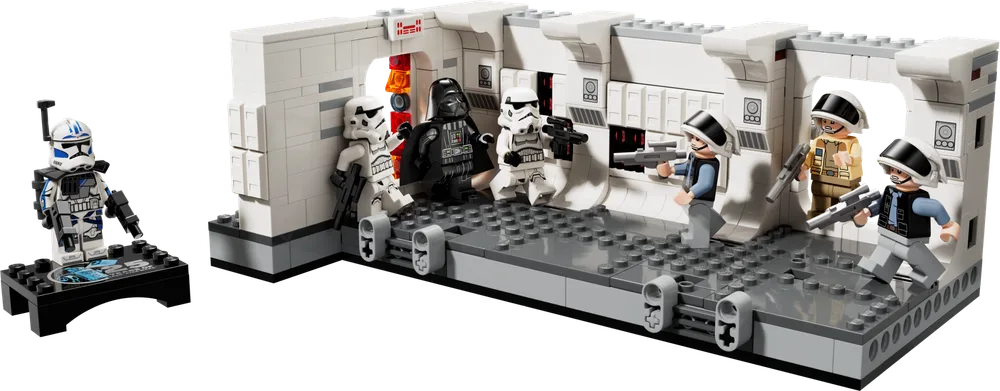 A LEGO Star Wars diorama showing Darth Vader, two Stormtroopers, and three Rebel Fleet Troopers engaged in battle within the white and gray corridor of the Tantive IV, with ARC Trooper Fives on a separate display base to the left.