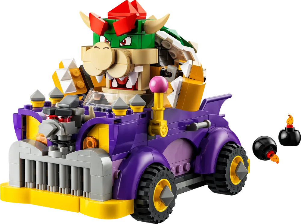 Bowser, a large green and yellow turtle-like character, sits in a purple, yellow, and grey muscle car with spikes. Two black Bob-ombs with flames are next to the car.