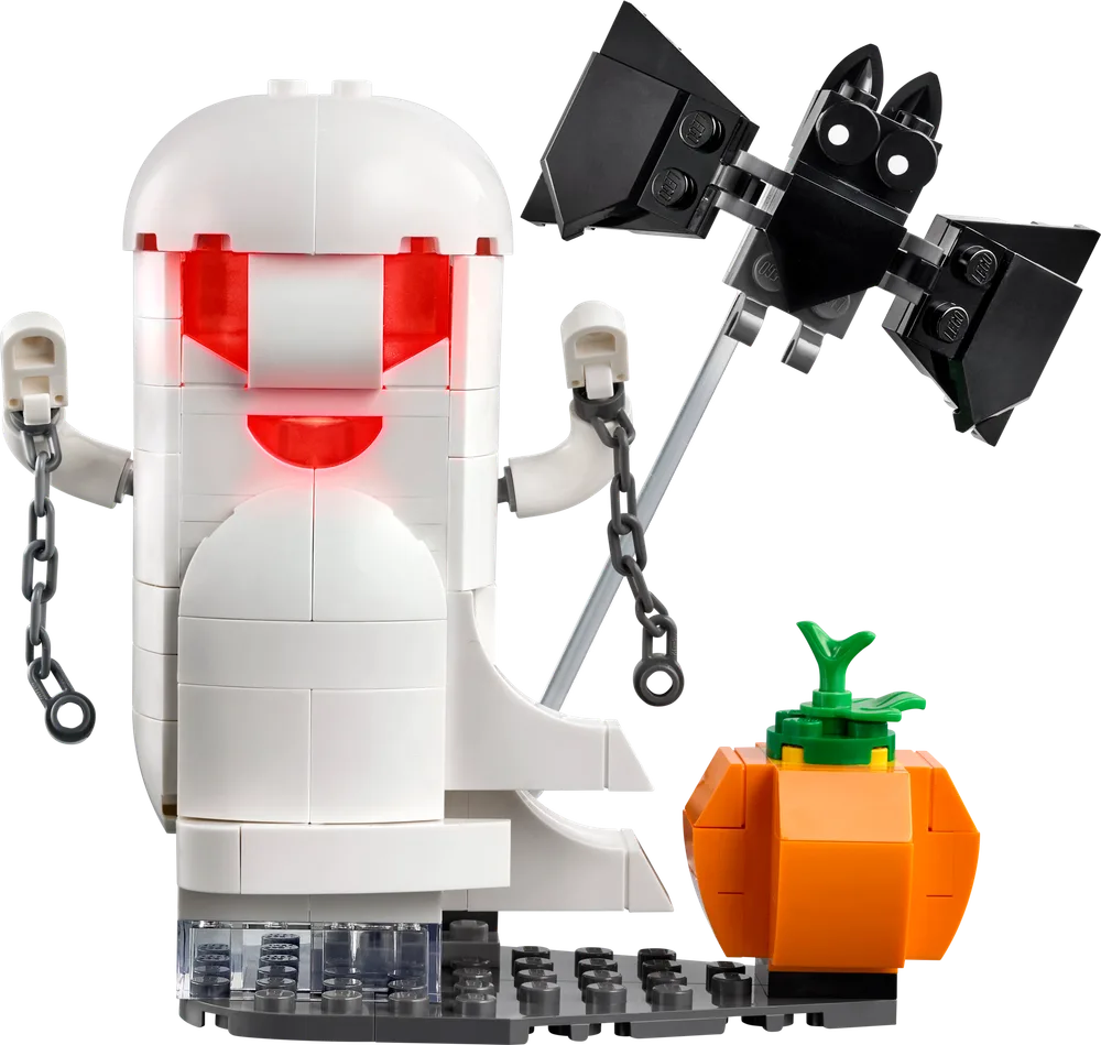 Close-up of the glowing white ghost build, a black bat on a pole, and an orange pumpkin, all on a grey base.
