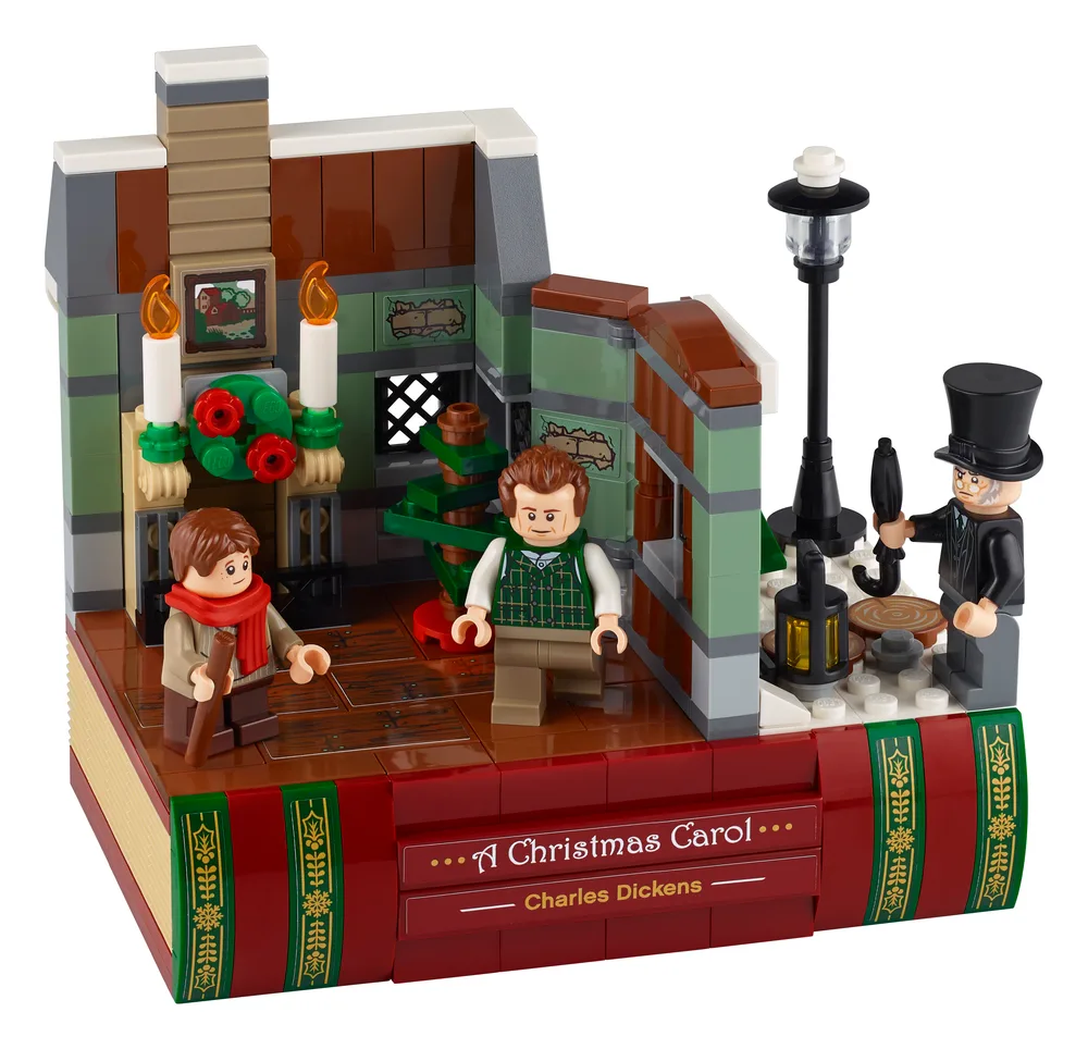 A detailed LEGO diorama of a Victorian street scene and an interior room, built on a book-shaped base, featuring three minifigures.