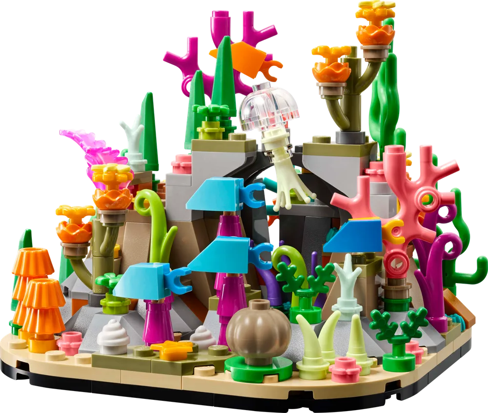 A vibrant LEGO coral reef diorama, featuring various colorful coral formations, sea plants, and a translucent jellyfish, built on a tan and black base.