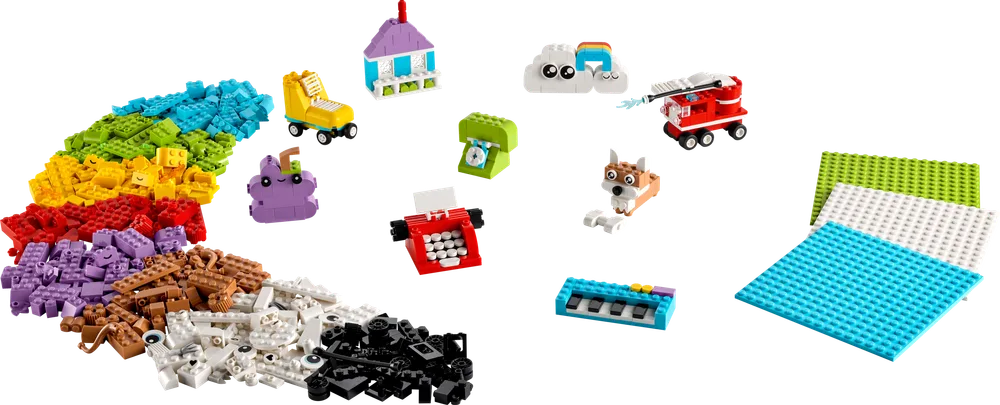 An expansive spread of LEGO Classic bricks in an arc of colors, with various small, imaginative models built from them, including a house, fire truck, dog, and typewriter.