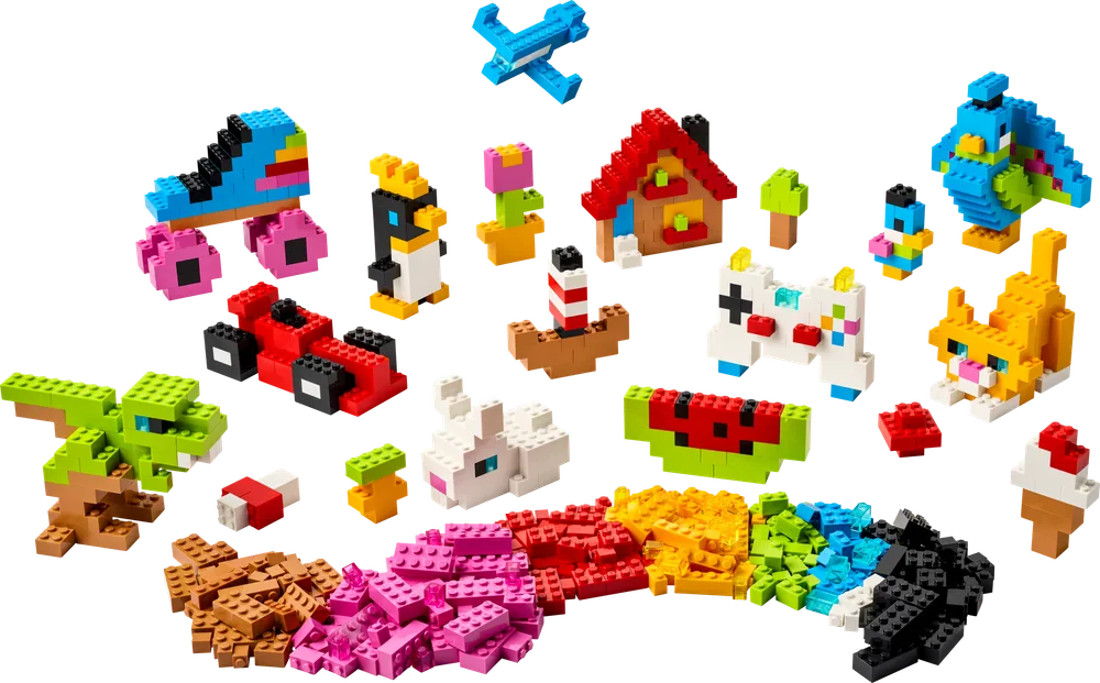 A wide variety of small, colorful LEGO creations including animals, vehicles, and objects laid out against a white background.