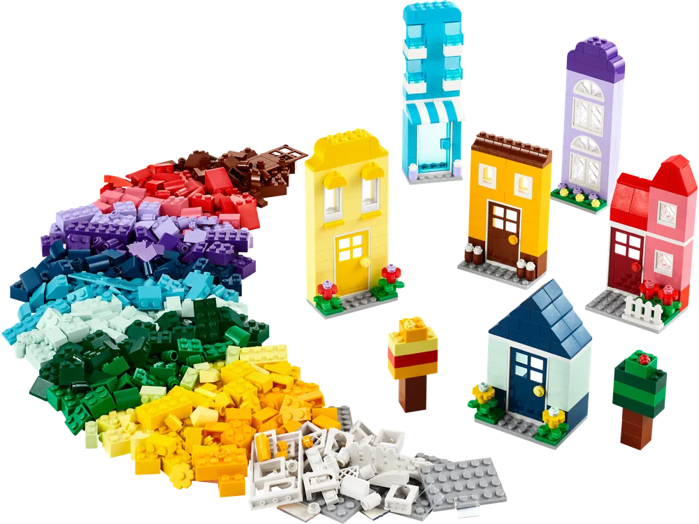 A vibrant spread of LEGO Classic Creative Houses set 11035 bricks, sorted by color, alongside several small, pre-built house models.