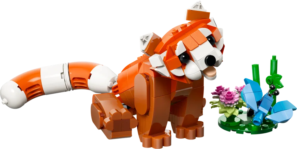A LEGO Red Panda, built from orange and white bricks, stands on a white background with a small green plant featuring pink flowers and a blue butterfly.