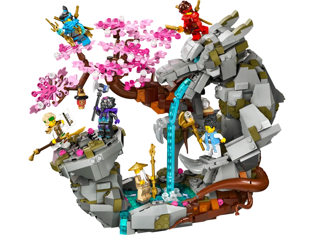 LEGO Ninjago Dragon Stone Shrine set 71819, showcasing the full build with a majestic stone dragon, a vibrant cherry blossom tree, a cascading waterfall, and several minifigures positioned dynamically.