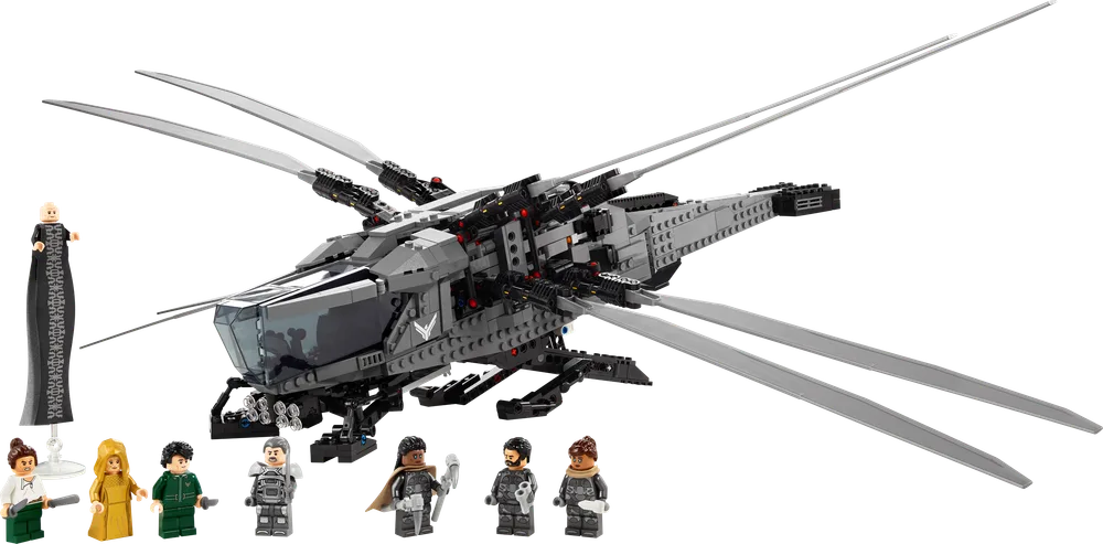 The LEGO Icons Dune Atreides Royal Ornithopter, a dark gray ship with splayed wings, is displayed with eight minifigures: Baron Harkonnen, Paul Atreides, Lady Jessica, Chani, Leto Atreides I, Gurney Halleck, Dr. Liet Kynes, and Duncan Idaho.