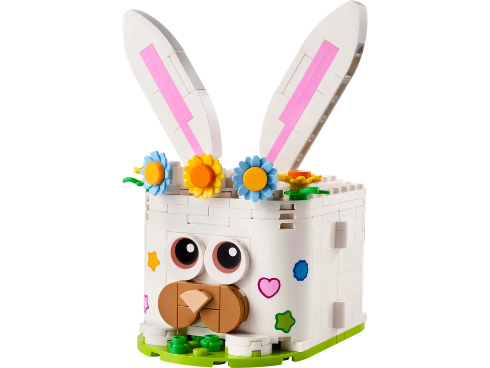A charming white LEGO Easter bunny, its face a square block with large round eyes and a brown nose, wearing a crown of colorful flowers, against a white background.