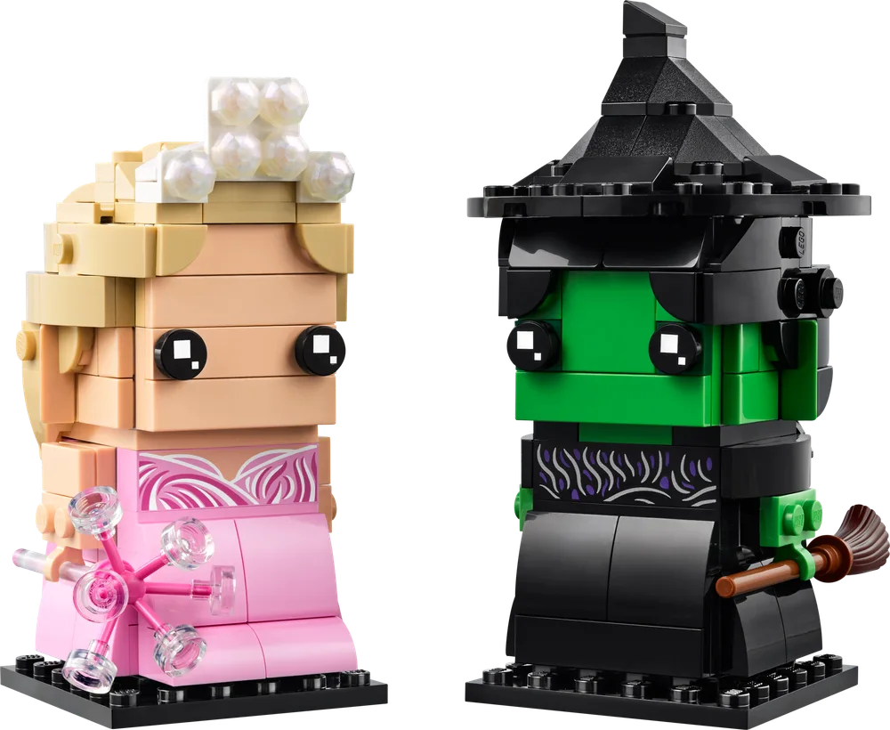 Front view of two LEGO BrickHeadz figures, Glinda in pink and Elphaba in green and black, standing side-by-side on black bases.