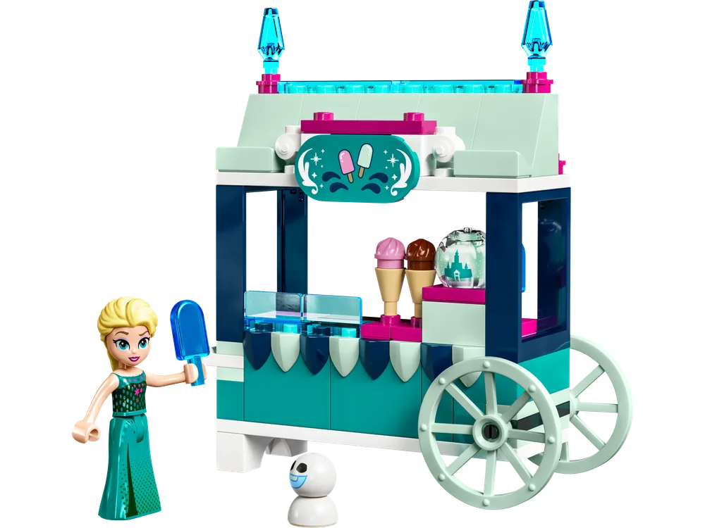 Elsa minifigure holding a blue popsicle next to her teal and white ice cream cart with a small Snowgie.