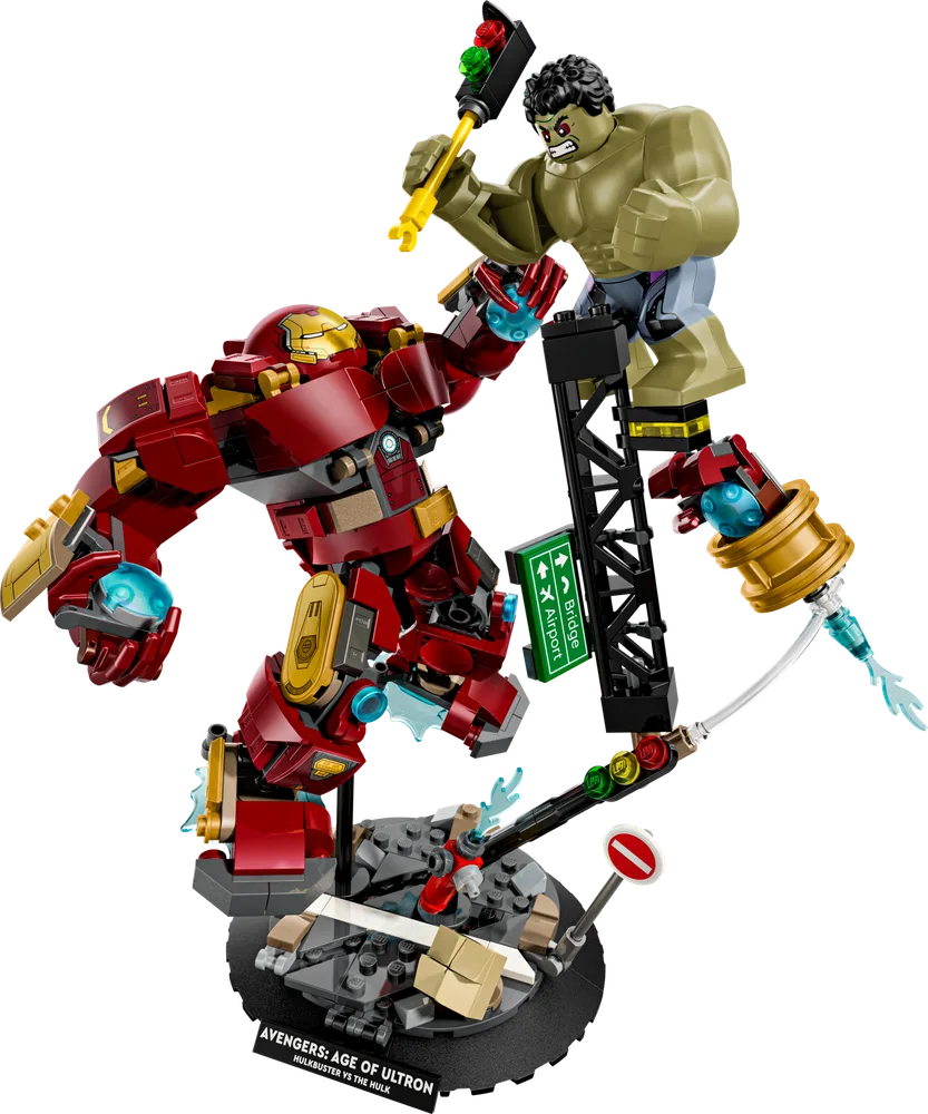 Hulkbuster vs The Hulk LEGO set in a dynamic action pose against a white background, featuring a destroyed street diorama and a small Iron Man minifigure.