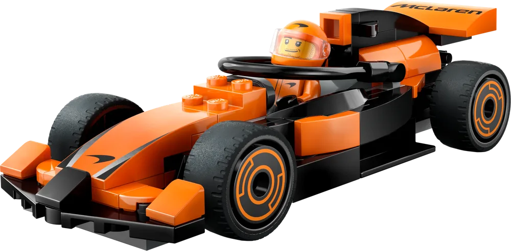 LEGO McLaren F1 race car with a driver minifigure in the cockpit. The car is orange and black with sleek lines.