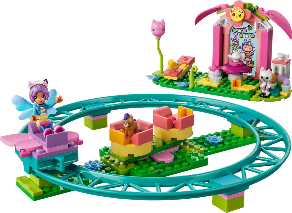 A whimsical teal roller coaster track forms an oval, with two small carts. One cart holds a fairy cat-girl minifigure, the other a small brown horse-like animal. To the right is a pink and green tea party gazebo with a white cat minifigure and various cupcakes.