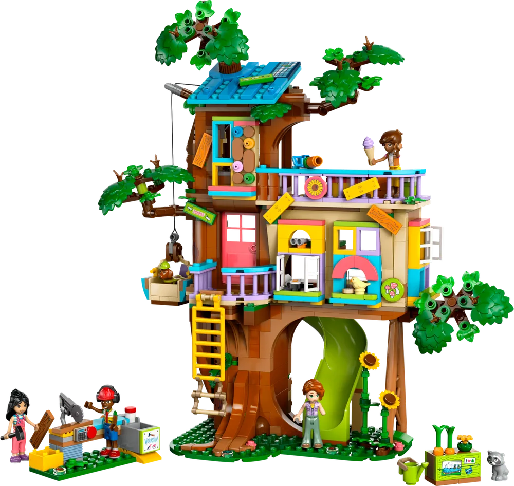 LEGO Friends Friendship Tree House set 42652, featuring a multi-level treehouse with various rooms, a slide, a workshop, and several minifigures and animal figures.