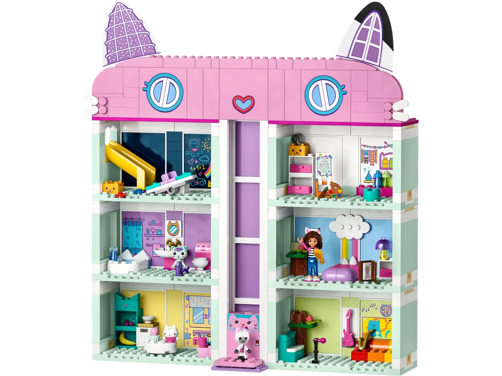 A front view of the assembled LEGO Gabby's Dollhouse, showcasing its multiple levels, various rooms, and cat-themed roof.