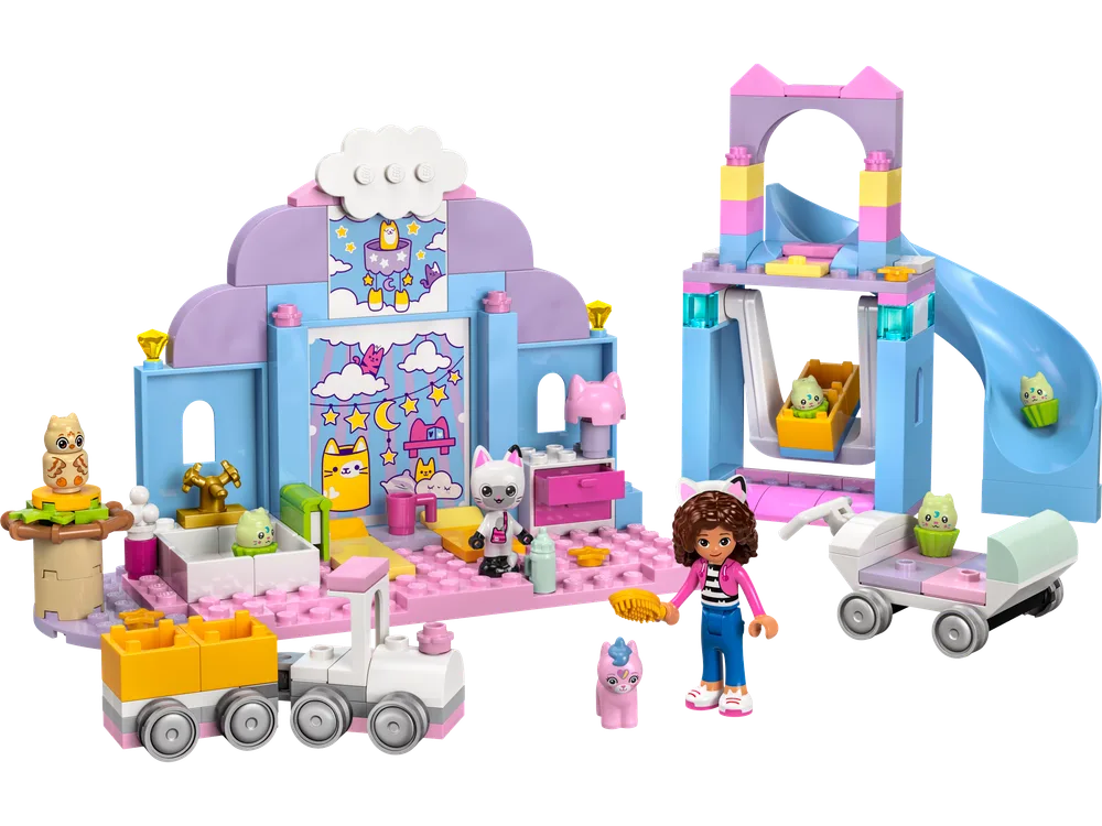 Full LEGO Gabby's Dollhouse Gabby's Kitty Care Ear set featuring a main building, slide, wagon, and minifigures on a white background.