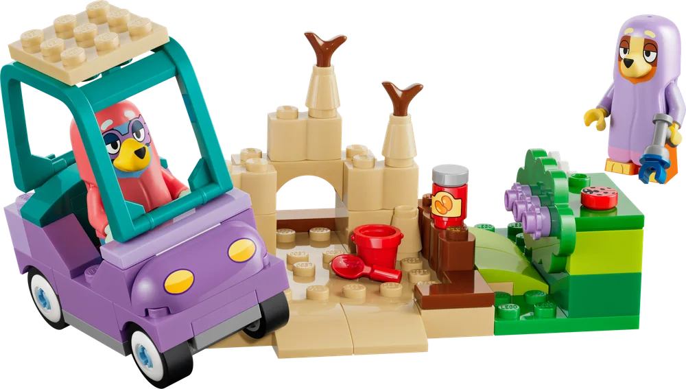 The complete LEGO Bluey Grannies set featuring a purple car driven by Granny Bingo in red, Granny Bluey in purple, a tan sandcastle, and various picnic accessories on a white background.