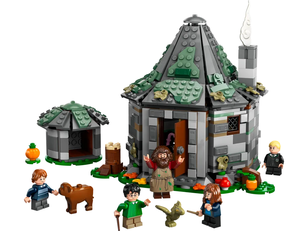 LEGO Hagrid's Hut, Fang, Harry, Ron, Hermione, Draco, and a baby dragon outside the hut and a small shed.
