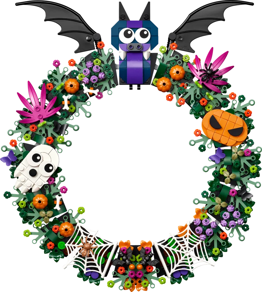 A vibrant LEGO Halloween Wreath, set 40825, featuring a purple bat at the top, a white ghost, orange jack-o'-lanterns, colorful foliage, and spiderwebs. The background is pure white.