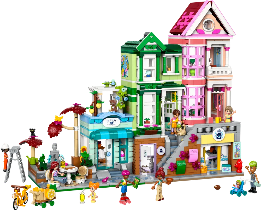 Full exterior view of the LEGO Friends Heartlake City Apartments, showcasing three colorful modular buildings, minifigures, an outdoor cafe, and street details.