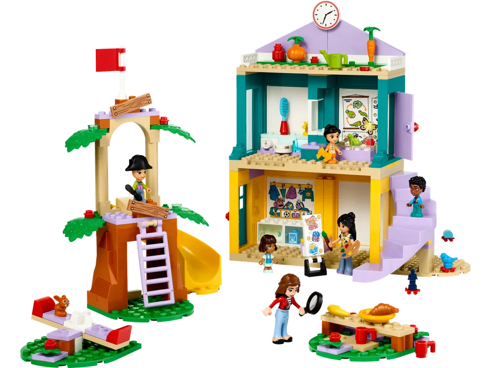 LEGO Friends Heartlake City Preschool 42636 full set with two main buildings, a treehouse and a multi-story schoolhouse, and several minifigures playing around them.