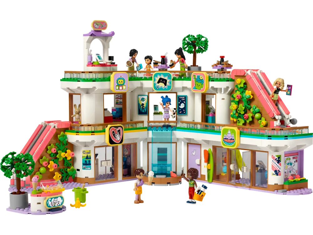 Front view of the LEGO Friends Heartlake City Shopping Mall set 42604, showing multiple levels, shops, escalators, and minifigures enjoying activities.