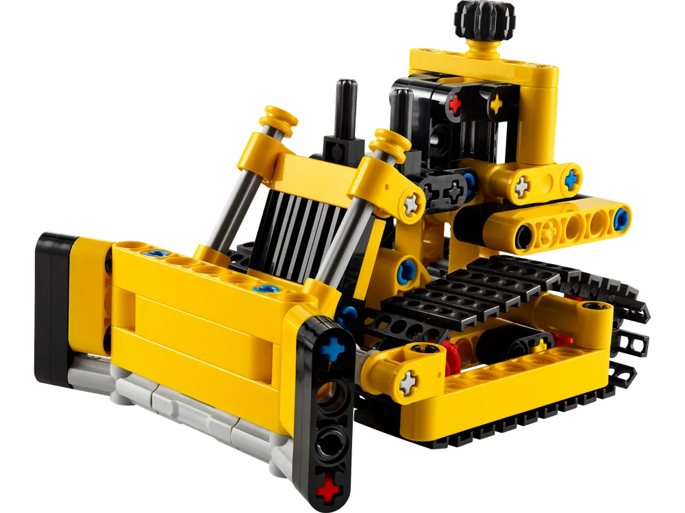 Front 3/4 view of the assembled LEGO Technic Heavy-Duty Bulldozer (42163) on a white background, highlighting its yellow blade and black track system.
