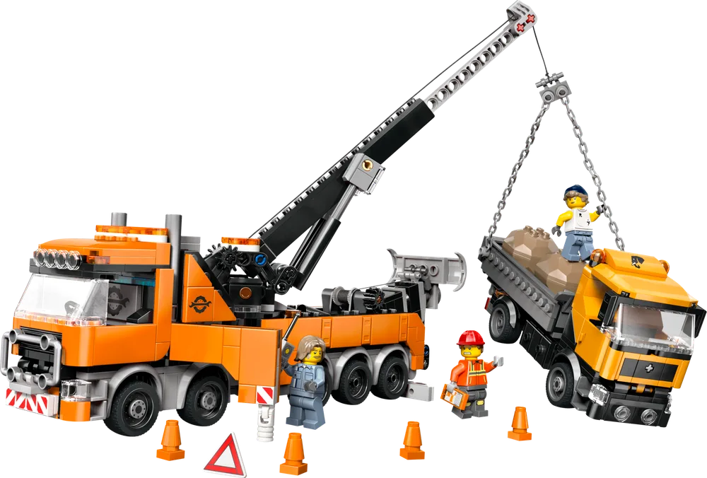 LEGO City 60467 Heavy-Duty Recovery Tow Truck in action, lifting a yellow dump truck with a crane and chain, with minifigures and road cones.