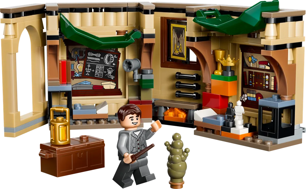 Harry Potter minifigure stands in an open LEGO Hogwarts™ Room of Requirement set, filled with items like a blackboard, fireplace, and green creature.