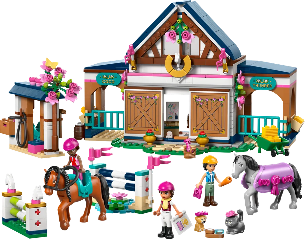The completed LEGO Friends Horse Stable and Riding Academy set from a front-facing perspective, showcasing the main stable building, two horses with minifigure riders, and a small jumping obstacle.