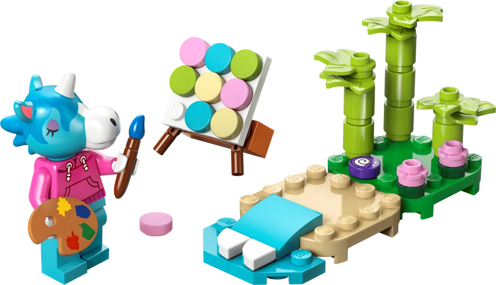 LEGO Animal Crossing Julian minifigure holding a paintbrush and palette, standing next to an easel with a colorful canvas and a small beach build with bamboo stalks.
