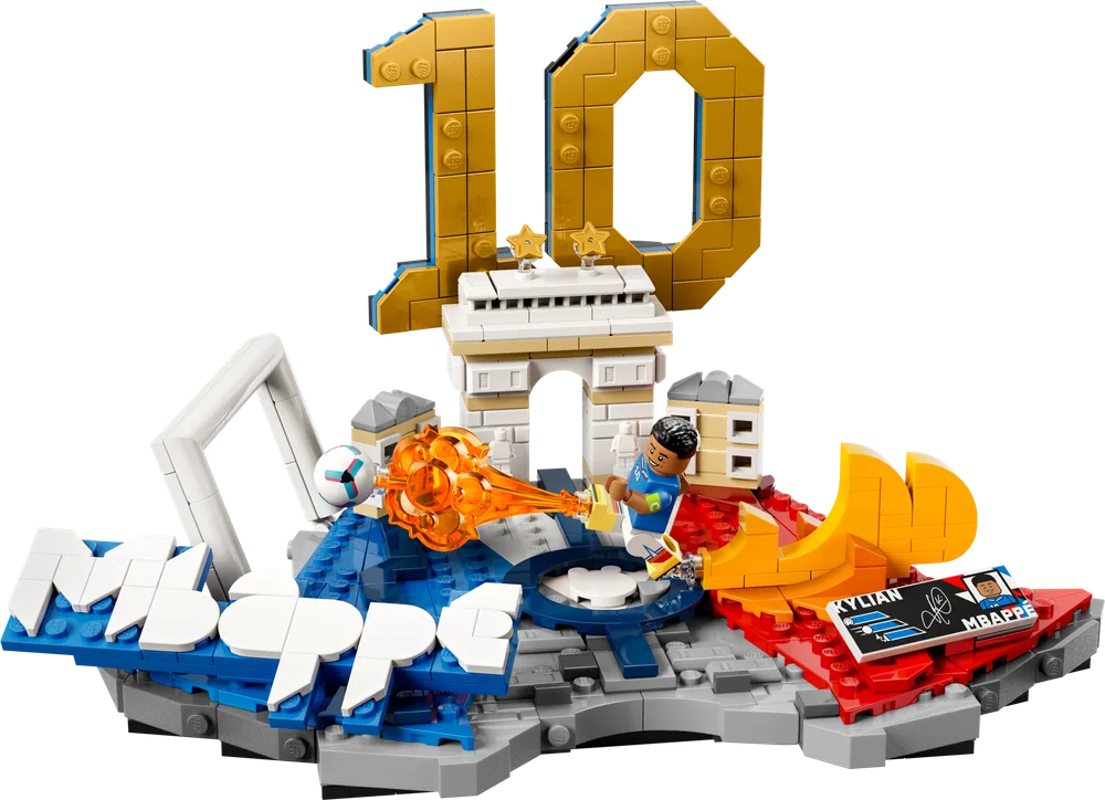A LEGO display set featuring a minifigure of Kylian Mbappé kicking a soccer ball, with a golden number 10, a small Arc de Triomphe, and the word 'MBAPPE' built into the base.