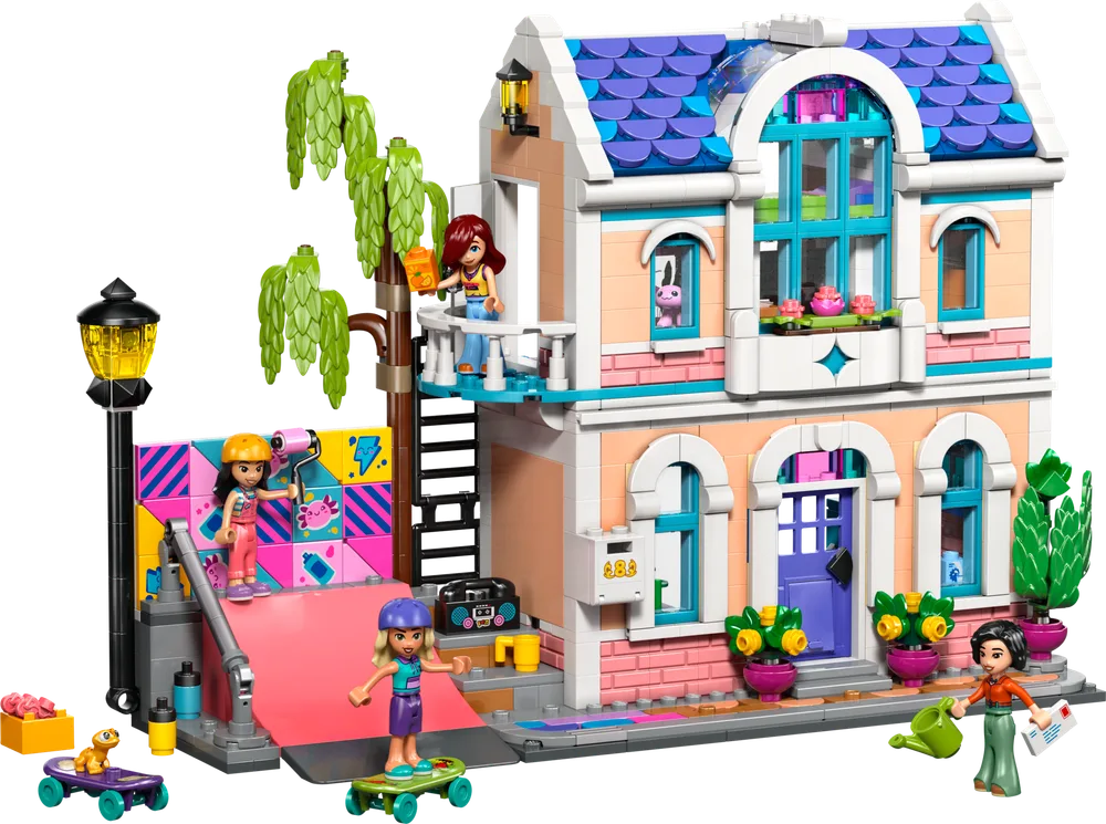 LEGO Friends Liann's Family House set 42687 front view with minifigures Liann, Autumn, Aliya, and Liann's mom, Michelle, with a skateboard ramp, art wall, and house details.