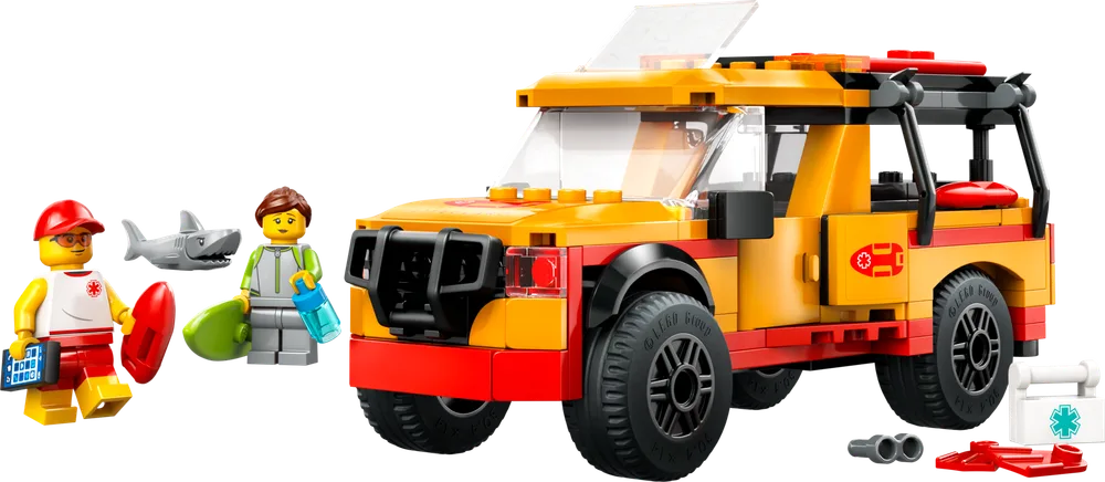 Full view of the LEGO City Lifeguard Truck, two minifigures, a gray shark, and various rescue accessories on a white background.