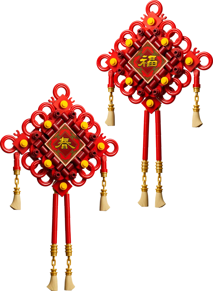 Two vibrant red and gold LEGO Lucky Knots, one featuring the character for 'spring' and the other for 'fortune', displayed against a white background.