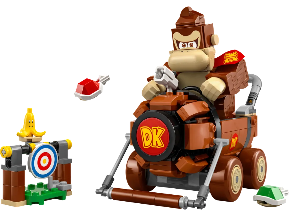 The LEGO Super Mario Donkey Kong figure sits in his brick-built brown DK Jumbo kart, with a red shell item floating next to him and a target build with a banana on top.