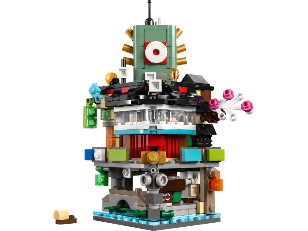 A detailed, front-facing view of the Micro NINJAGO® City LEGO build against a white background, showcasing its intricate layers and colorful architectural elements.
