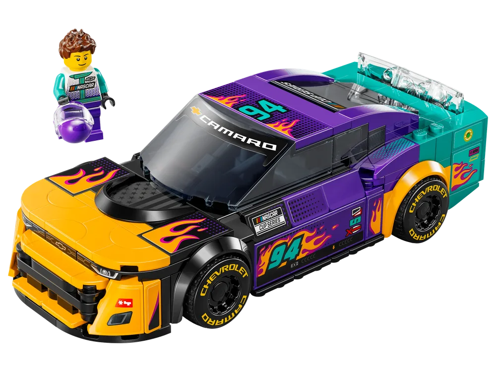 Front 3/4 view of the LEGO Speed Champions NASCAR Next Gen Chevrolet Camaro ZL1 with its driver minifigure standing beside it.