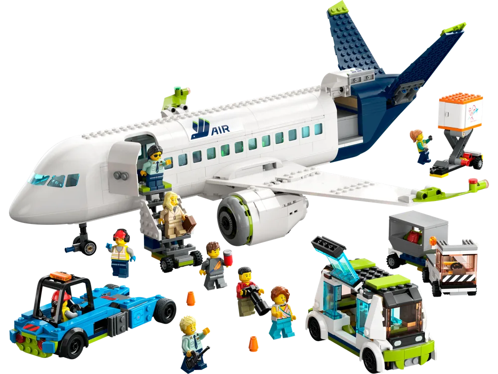 A wide shot of the LEGO City Passenger Airplane set (60367) on a white background, featuring the white and blue airplane, several ground support vehicles, and 9 minifigures interacting with the scene, showing a bustling airport ground operation.
