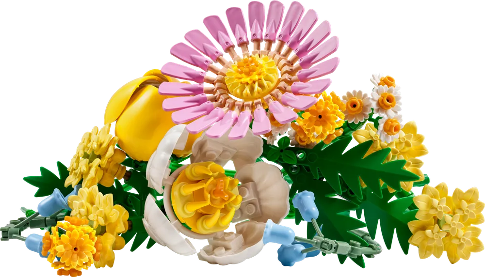 Close-up view of the various LEGO flowers from the Petite Sunny Bouquet, featuring a pink daisy, yellow tulip, and white opening blossom, along with smaller yellow and blue flowers.