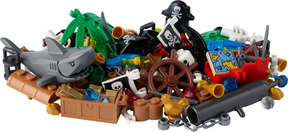 A close-up, dynamic pile of LEGO pirate-themed elements, including a shark, treasure chest with gold, steering wheel, palm tree, cannon, and various pirate accessories, scattered on a white background.