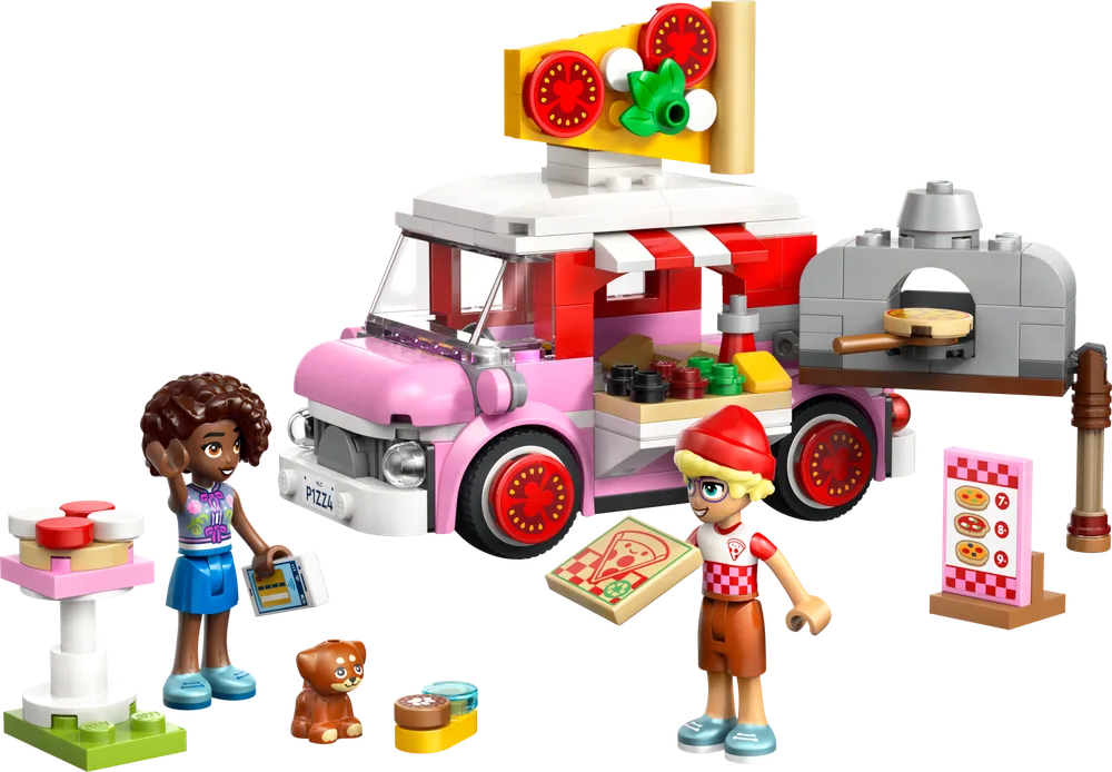 The LEGO Friends Pizza Truck set is displayed with two minifigures, a dog, the pink and white truck with a pizza sign, a separate pizza oven, a menu board, and a small table.