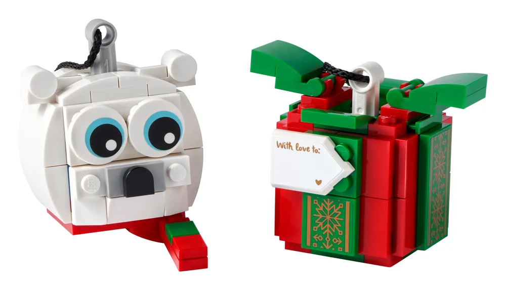 Two LEGO Christmas ornaments, a white polar bear and a red and green gift box, displayed on a white background.