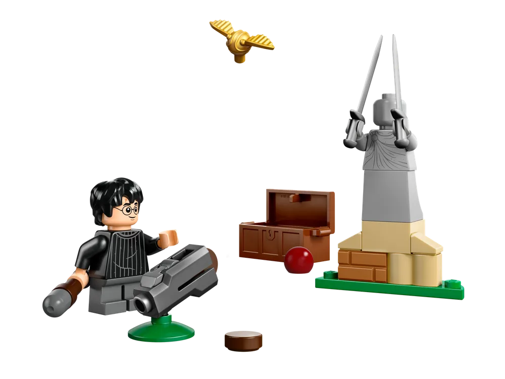 A LEGO Harry Potter minifigure sits on a grey and green launcher, aiming at a golden Snitch flying above. To the right is a brown chest and a small red ball, next to a grey and tan statue holding two silver swords.