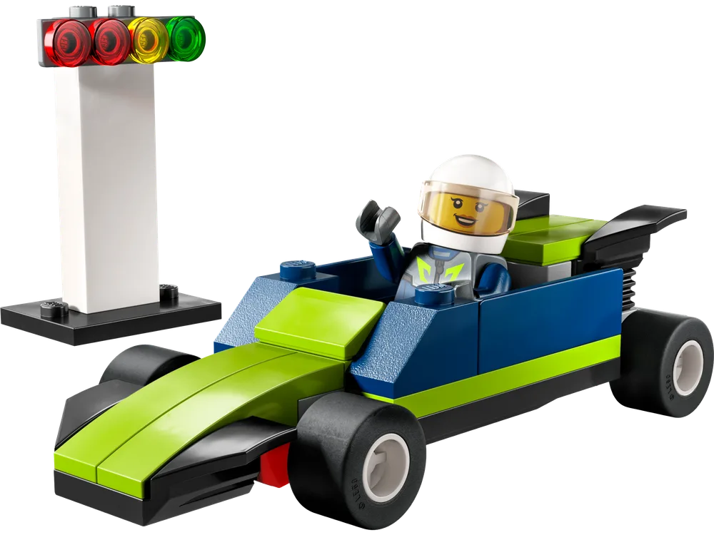 A lime green and blue LEGO race car with a driver minifigure waving, next to a black and white starting light with red, yellow, and green circular lights.