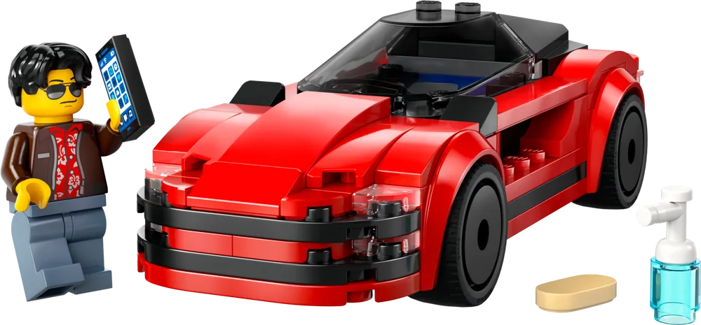 A red LEGO sports car with black detailing, a transparent windshield, and an enthusiastic minifigure, Kai, holding a smartphone and standing next to a sponge and a blue spray bottle.